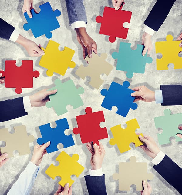 Real Estate And Business Litigation Law Firm - Hands holding puzzle pieces.